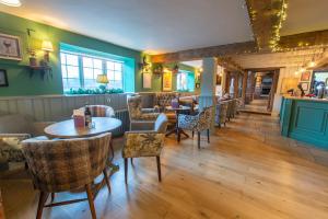a restaurant with tables and chairs and a bar at Cross Keys by Chef & Brewer Collection in Nunthorpe