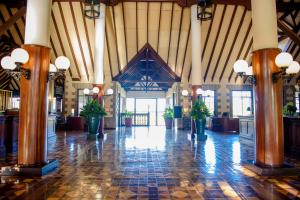 a large hall with potted plants in a building at Windsor Golf Hotel & Country Club in Nairobi