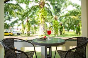un bicchiere di vino seduto su un tavolo sotto un portico di Green Garden House ad Ao Nam Mao
