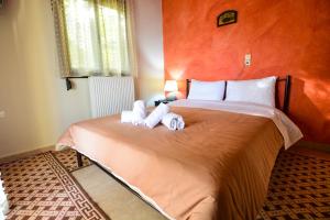 a bedroom with a bed with two stuffed animals on it at The Theater of Dreams in Synikia Mesi Trikalon