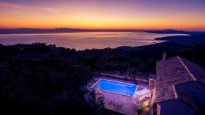 an aerial view of a house with a swimming pool at Villa Aria in Agios Nikolaos
