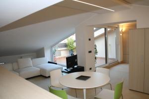 a living room with a table and a couch at La Terrazza sull'Arena in Verona