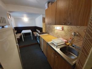 a small kitchen with a sink and a table at Chata Veronika in Terchová