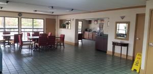 a dining room and kitchen with a table and chairs at Super 8 by Wyndham Ruther Glen Kings Dominion Area in Ruther Glen
