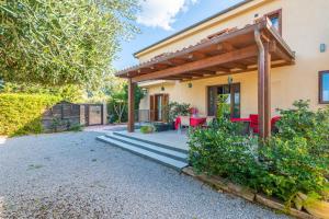 a patio of a house with a table and chairs at B&B Le Dune - Self Check in in Lascari