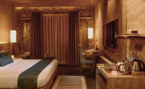 A bed or beds in a room at Sarangkot Mountain Lodge