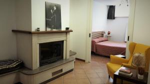 a living room with a fireplace and a bedroom at Appartamento La Carambola 110mq in Maglie