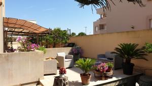 a balcony with potted plants on a building at Appartamento La Carambola 110mq in Maglie