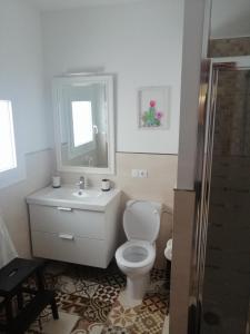 a bathroom with a toilet and a sink and a mirror at Mary's Home in Moya