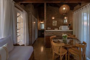 a kitchen and dining room with a glass table at Carilo Village Apart Hotel & Spa in Carilo