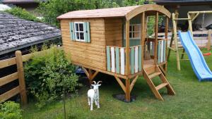 a goat standing in front of a play house at Villa Zeppelin - App Aquamarin in Bramberg am Wildkogel