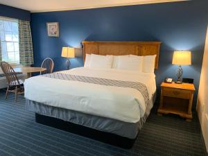 The Lodge at Jackson Village في جاكسون: غرفة فندقية بسرير كبير وطاولة