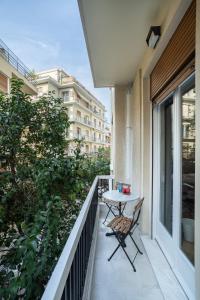 a patio with a table and chairs on a balcony at A Short Walk to Syntagma and Plaka by Athenian Homes in Athens