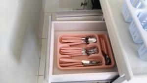 a drawer with some utensils in a refrigerator at Residencial Dom Laurindo in Paulo Afonso