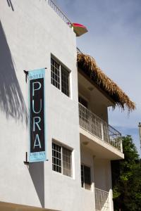 a white building with a hotel sign on it at Hotel Pura Chacala in Chacala