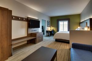 a living room with a couch, chair and a television at Holiday Inn Express Hotel & Suites Austell Powder Springs, an IHG Hotel in Austell