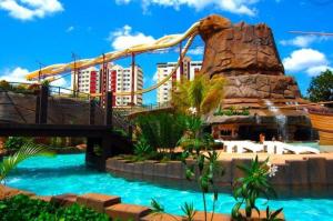 a water slide in a resort with a roller coaster at Piazza DiRoma Caldas Novas in Caldas Novas
