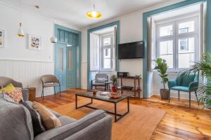 a living room with a couch and a table at LV Premier Baixa DO in Lisbon