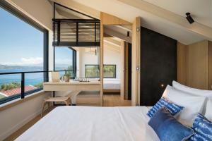 A bed or beds in a room at OPENNESS House by the sea