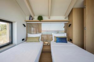 A bed or beds in a room at OPENNESS House by the sea