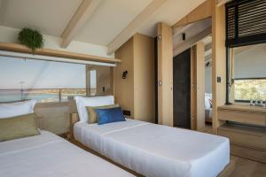 A bed or beds in a room at OPENNESS House by the sea