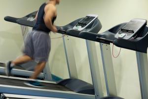 a man running on a treadmill in a gym at Saray Musheireb Hotel Suites and Apartment in Doha