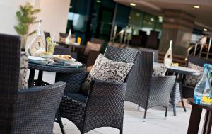 a group of chairs and tables in a restaurant at Saray Musheireb Hotel and Suites in Doha