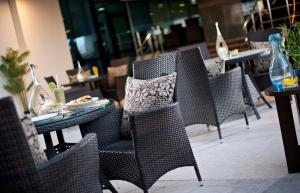 a group of chairs and tables in a restaurant at Saray Musheireb Hotel Suites and Apartment in Doha