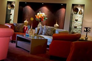 a living room with couches and a table at Saray Musheireb Hotel Suites and Apartment in Doha