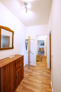 a bathroom with a wooden vanity and a mirror at Ferienwohnung 131 in Annaberg-Buchholz