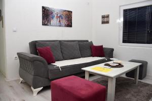 a living room with a couch and a table at Markos Towers Apartments in Prilep