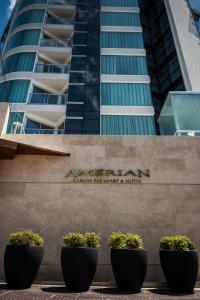 
a row of tall buildings with large windows at Amérian Carlos Paz & Suites in Villa Carlos Paz
