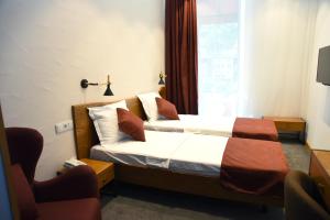 Letto o letti in una camera di R&R Hotel
