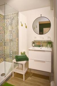 a bathroom with a sink and a shower at Les Patis in Vouvray