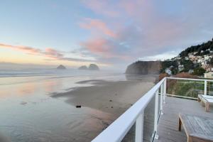 a view of the beach at sunset with haystack rocks at The Oceanside Inn in Oceanside