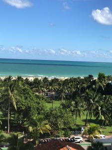 a view of the beach from the balcony of a resort at Dream Destinations at Ocean Place in Miami Beach