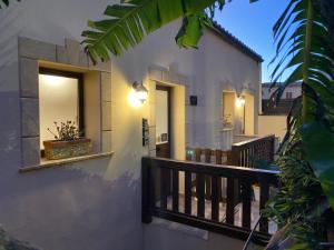 a house with two windows and a balcony at B&B Donna Teresa in Agrigento