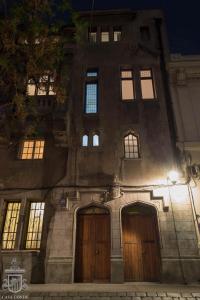 a building with two doors and windows at night at Hotel Boutique Casa Conde in Santiago