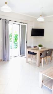 a dining room with a wooden table and chairs at Elias Apartments in Nydri