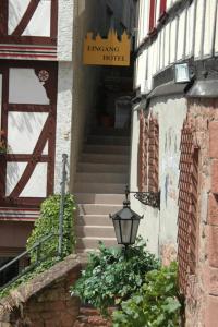 a stairway leading to a building with a street light at Altstadt-Hotel Gelnhausen in Gelnhausen
