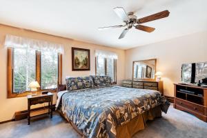 a bedroom with a bed and a ceiling fan at Cleerwood Village #269 in Eagle River