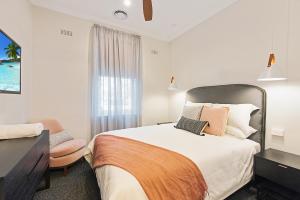 a hotel room with a bed and a window at Luxury on the Esplanade in Echuca