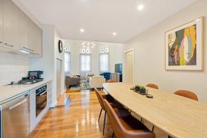 a kitchen and dining room with a table and chairs at Luxury on the Esplanade in Echuca