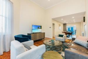 a living room with a couch and a tv at Luxury on the Esplanade in Echuca