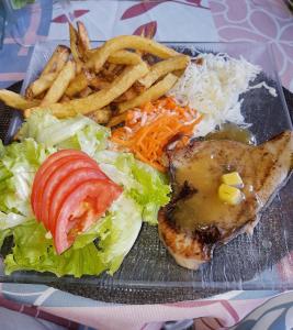 a plate of food with a sandwich and french fries at La Villa Des Lys in Saint-Pierre