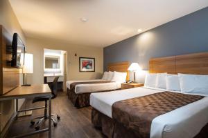 a hotel room with two beds and a desk at SureStay Hotel by Best Western Fairfield Napa Valley in Fairfield +9 photos