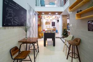 un restaurante con taburetes, mesa y piano en HOSTIE SAIGON [WANDERLUST Home], en Ho Chi Minh