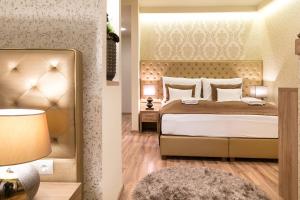 2 imágenes de un dormitorio con una cama y una lámpara en Főtér Rezidencia 3 en Győr