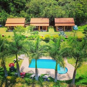 uma vista aérea de um resort com uma piscina e palmeiras em Pousada Caruaru em Socorro
