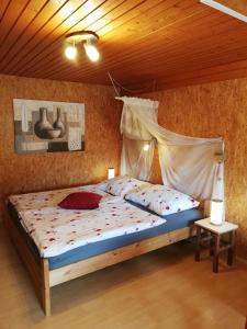 a bedroom with a bed with a mosquito net at Almland Hütte in Pusterwald